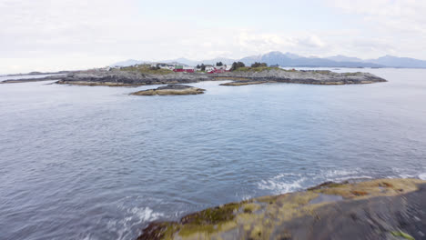 areal reveal shot of small settlement on a nordic island