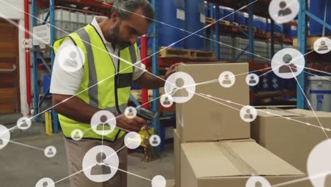 Animation-of-connected-profile-icons-over-biracial-man-scanning-barcode-on-boxes-at-warehouse