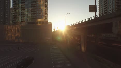 aerial shot rising up over a highway in a busy city core