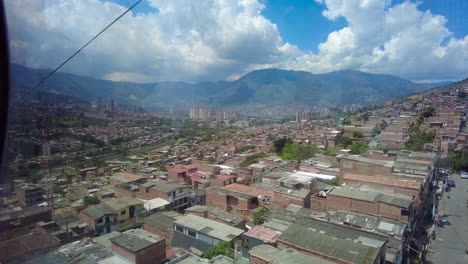 Marvel-at-the-towering-skyscrapers-and-bustling-streets-of-Medellin,-Medellín-from-a-glass-window,-Colombia