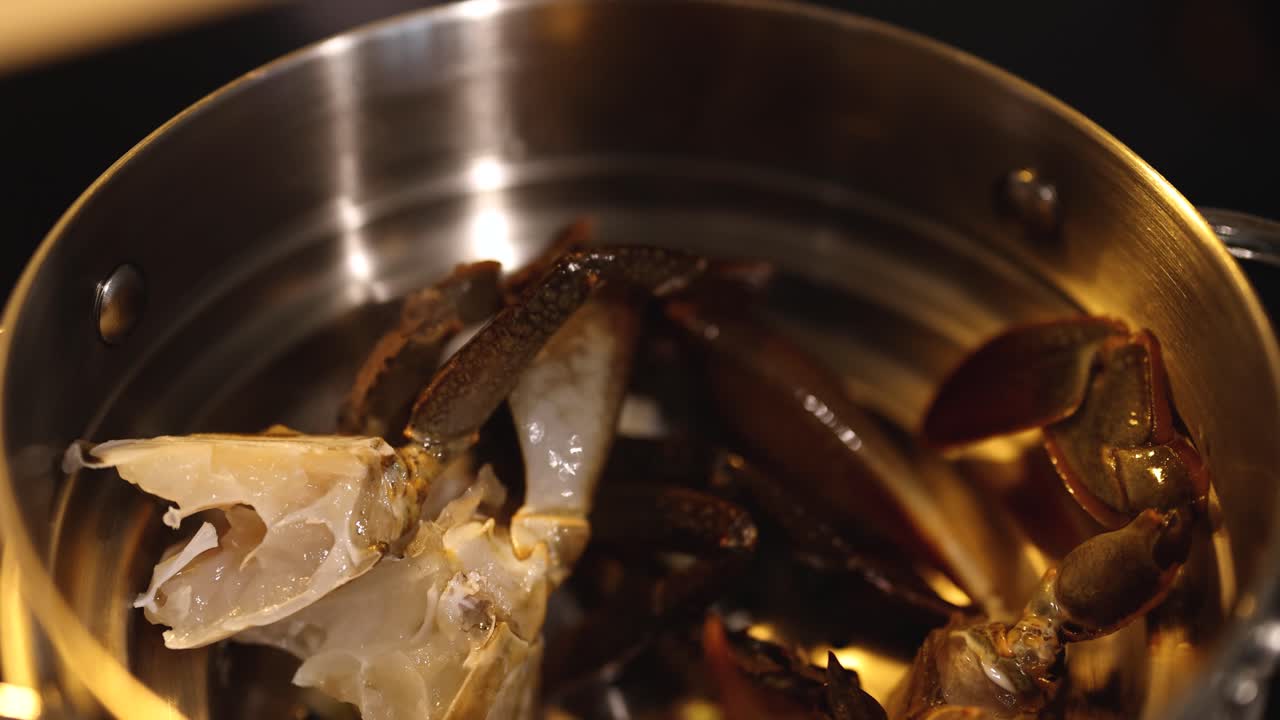 Steaming crab legs in a stainless steel pot