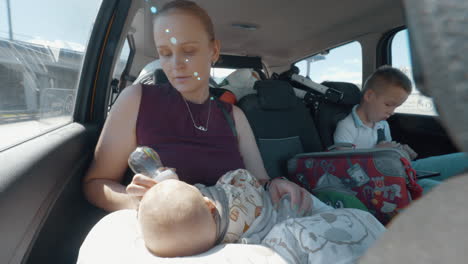 mother with two kids going on holiday by car