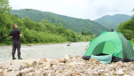a satisfied young tourist enjoys the beauty of the summer landscape in the mountains a satisfied young tourist enjoys the beauty of the summer landscape in the mountains ecological tourism rest in deserted places