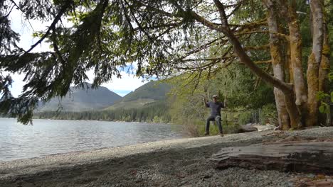 swinging on rope with lake and mountains in the background