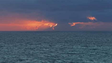 slowmotion wide drone shot of big ocean waves and cloudy sunset
