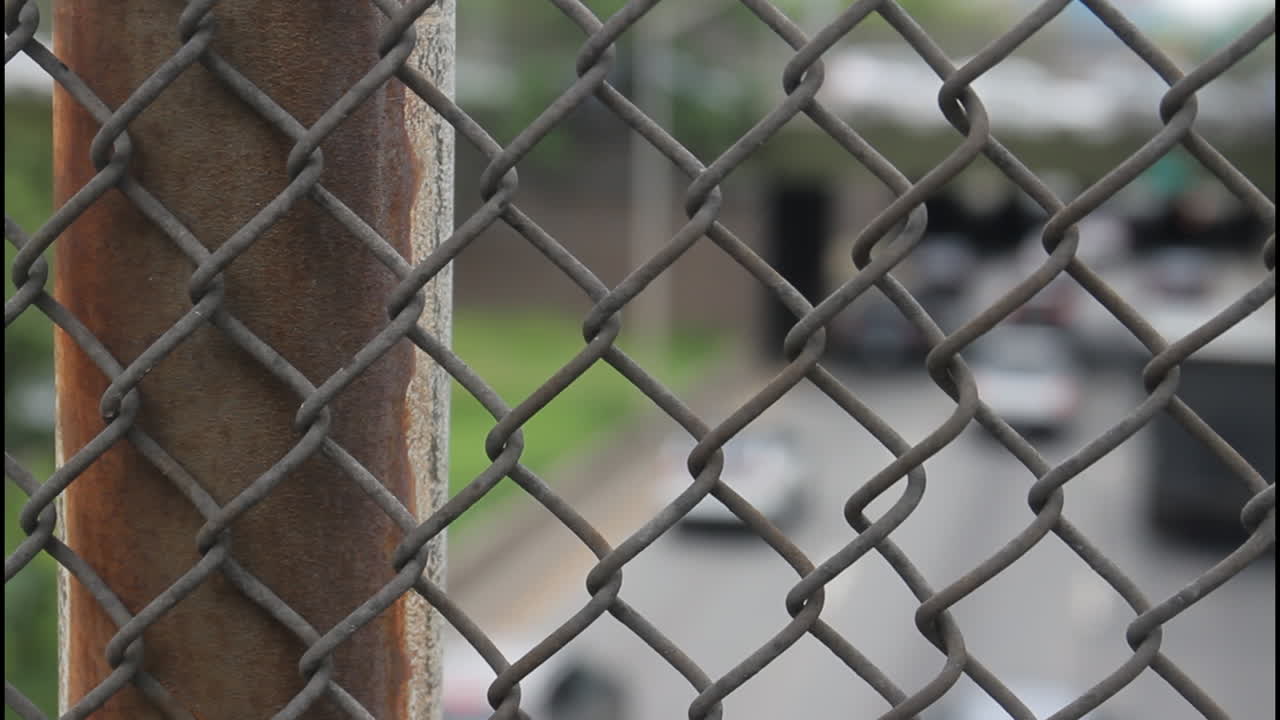 Chain Link Fence Overlooking Highway Traffic