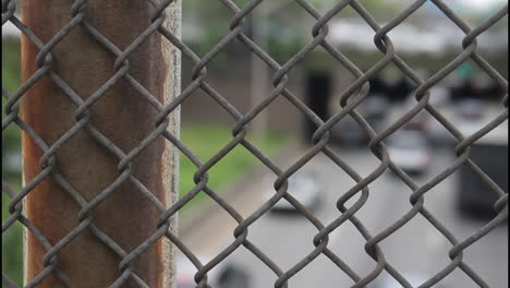 chain link fence overlooking highway traffic