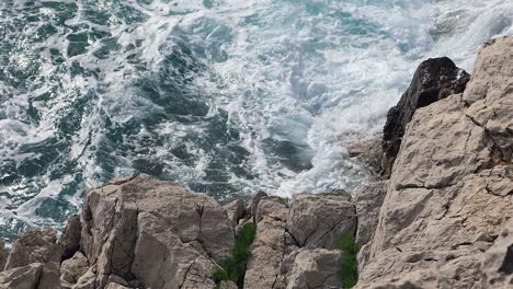 sea waves behind the white rocks