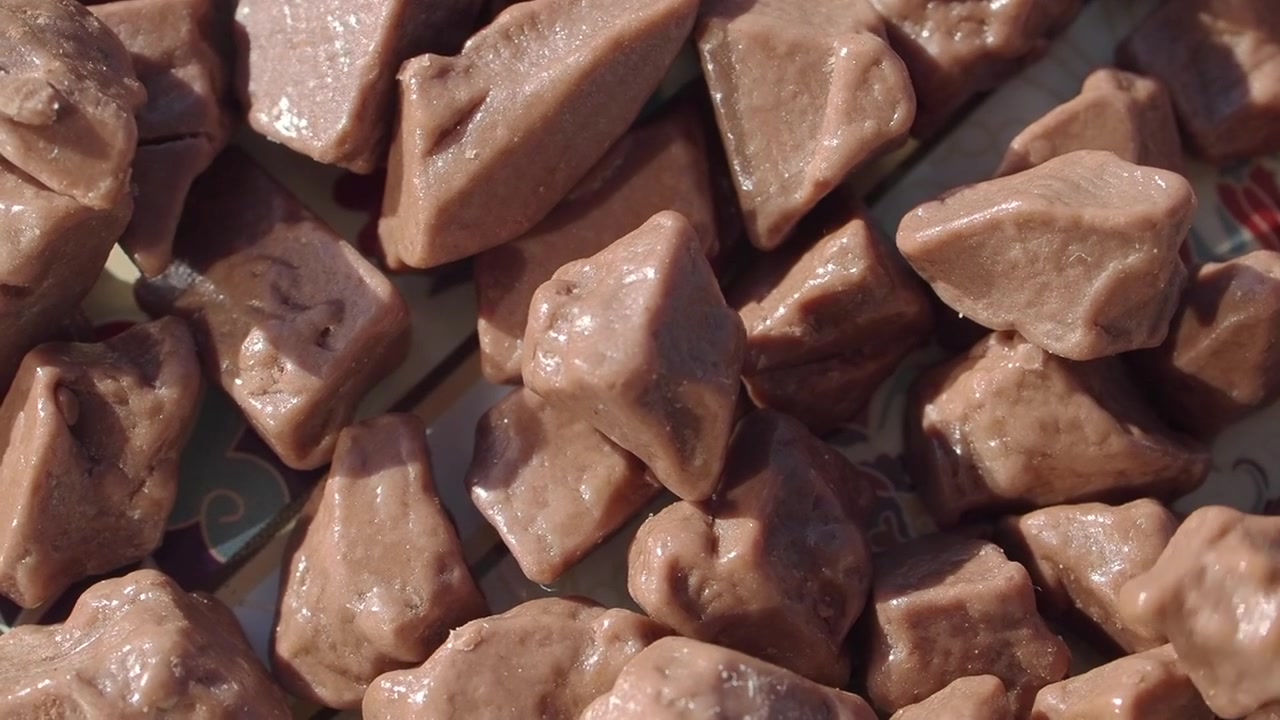 Chocolate Chunks Falling onto a Decorative Plate