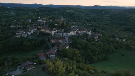 Vista-Aérea-De-La-Ciudad-Histórica-De-La-Cima-De-La-Colina-De-Piemonte-Carpeneto-Y-El-Palacio-Del-Norte-De-Italia-Al-Atardecer