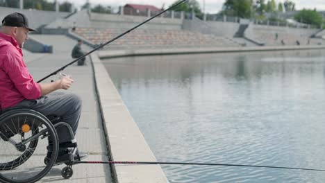 person with a physical disability who uses wheelchair fishing from fishing pier