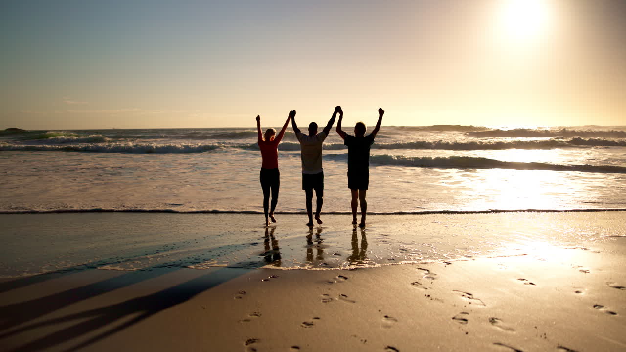 People celebrating on the beach at sunset