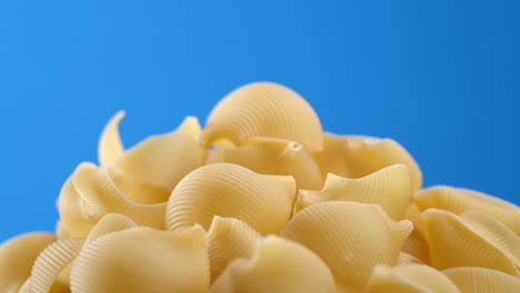 a bunch of dry pasta is slowly rotating.