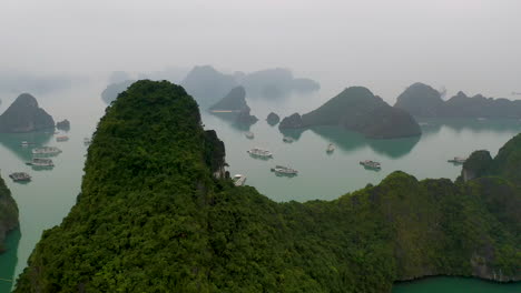 Breathtaking-aerial-of-tour-boats-gathered-in-iconic-Ha-Long-Bay,-Vietnam