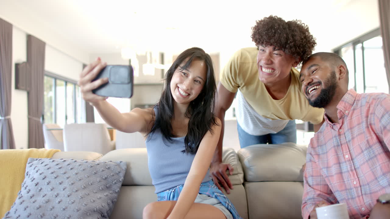 Taking selfie, Diverse friends smiling and enjoying time together on couch