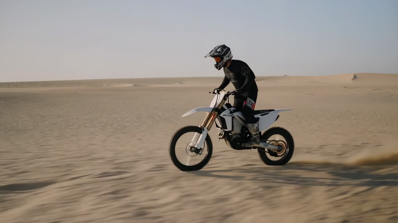 Motocross Rider on Dirt Bike in Desert Dunes