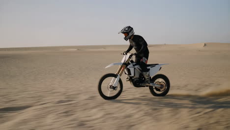 motocross rider on dirt bike in desert dunes