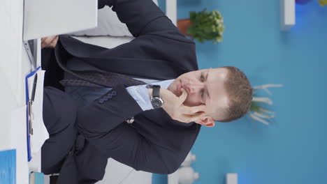 vertical video of home office worker man thinking worriedly.