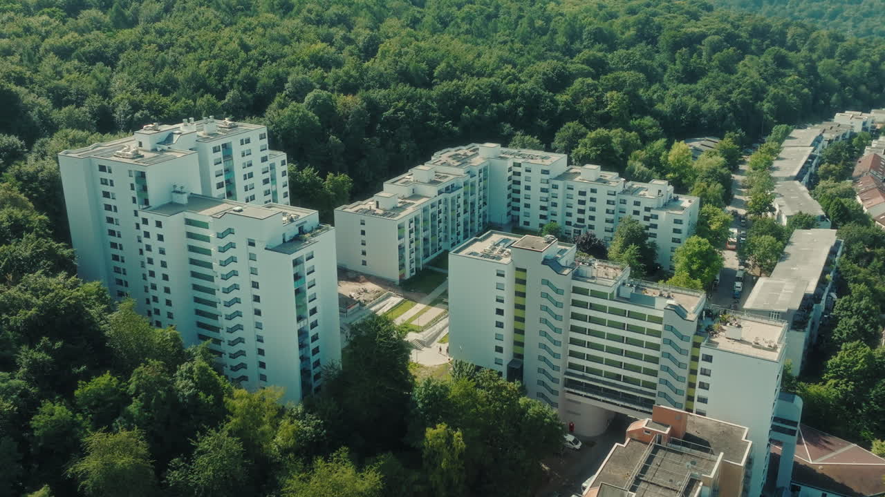 Parallax drone shot of Emmertsgrund neighborhood and white buildings during the day in Heidelberg, state of Baden-Wurttemberg, Germany