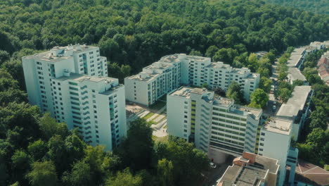 parallax drone shot of emmertsgrund neighborhood and white buildings during the day in heidelberg, state of baden-wurttemberg, germany