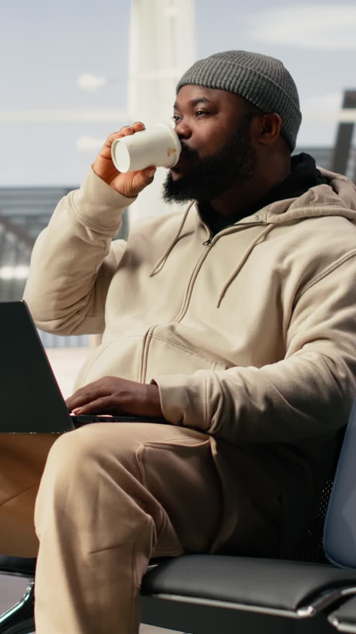 Vertical Video Remote worker, airport lounge waiting, using laptop before flight departure
