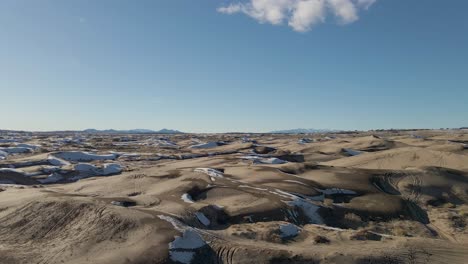 aerial forward over sand dunes on winter day, little sahara desert