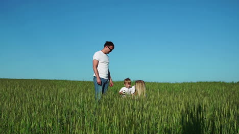 Happy-family:-father-mother-and-son-in-the-field-talking-and-laughing