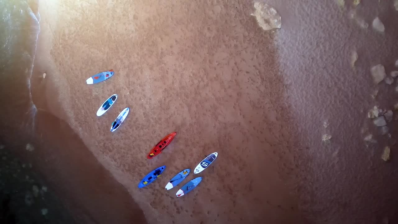 An incredible aerial perspective inside Benagil Cave, Algarve, Portugal. This footage captures the magnificent natural skylight, illuminating the sandy beach and the vibrant kayaks in the cave.