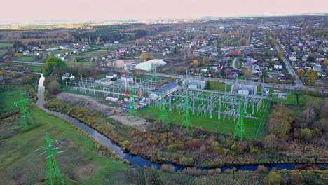 electrical power substation at a town in europe feeds into transmission terminals - aerial view