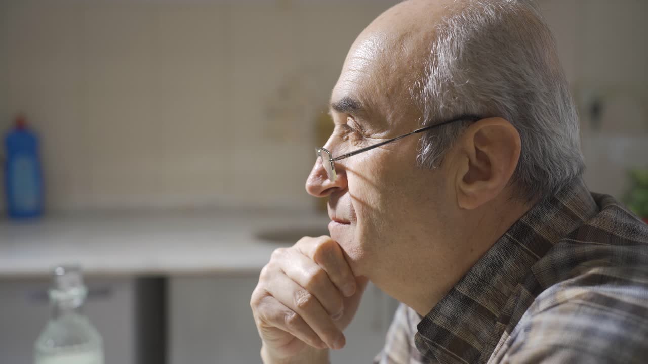 Thoughtful old man is sitting.