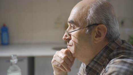 thoughtful old man is sitting.