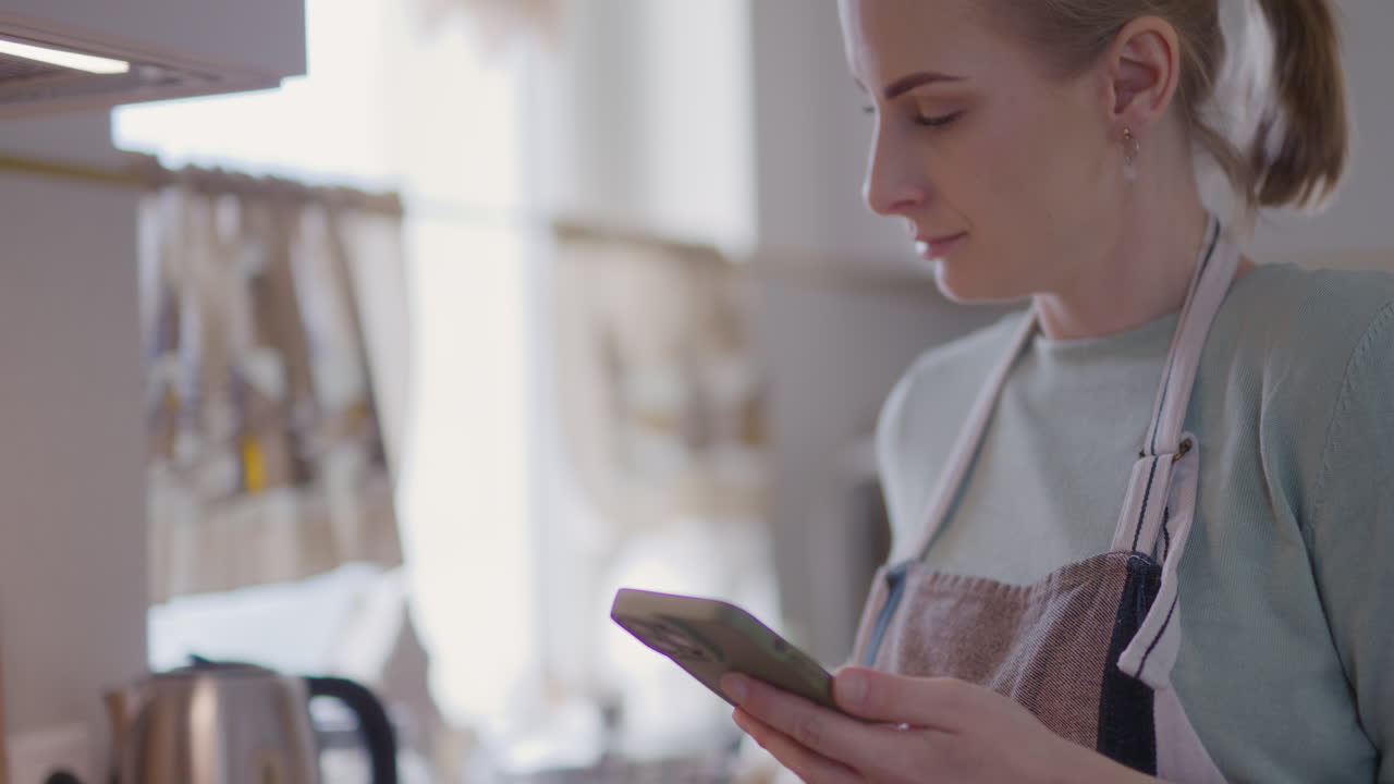 женщина читает рецепт во время выпечки на сковородке на кухне