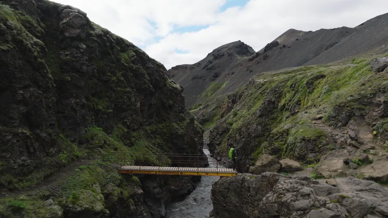 Laugavegur trail, Hiker on the bridge over the Fremri river, Iceland