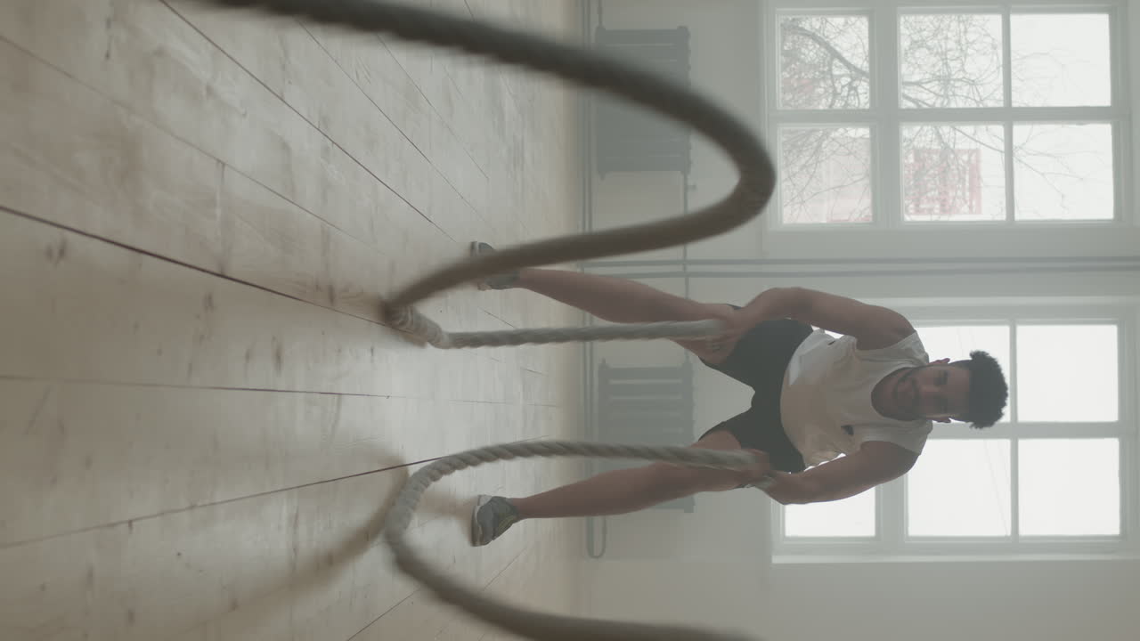 African American Man Exercising With Battle Rope