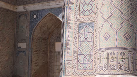 detailed-tiling-and-artwork-on-front-of-islamic-architecture-in-Samarkand,-Uzbekistan-along-the-historic-Silk-Road