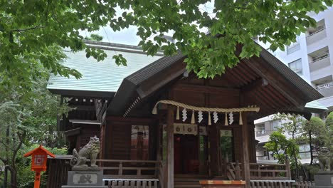 the main hall of kuramae shrine with its traditional wooden architecture, nestled amidst lush green foliage, showcasing a serene spiritual atmosphere.
