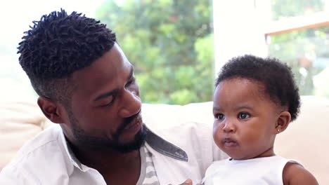 Father-with-his-baby-daughter-on-the-couch