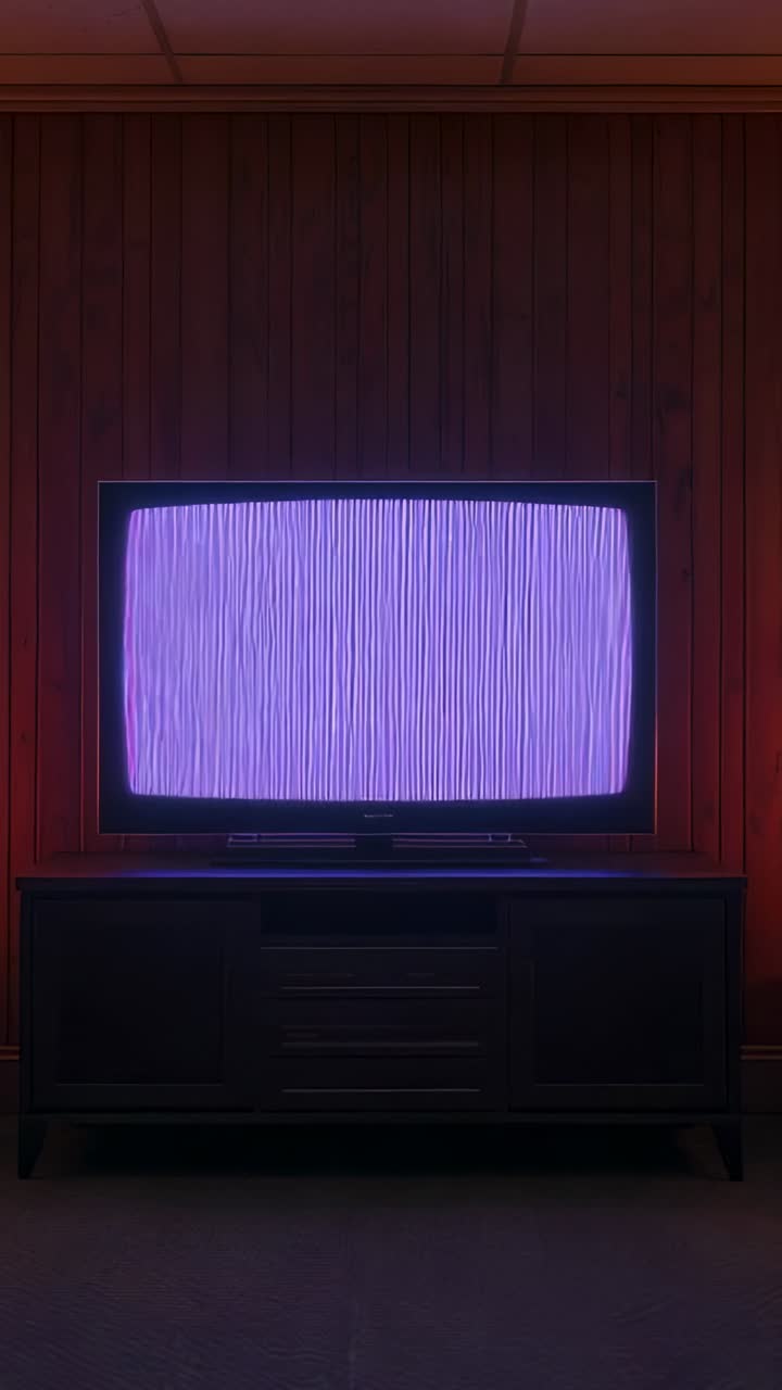 Vertical video: Flickering static on television set shifting from lavender to purple glow in cellar