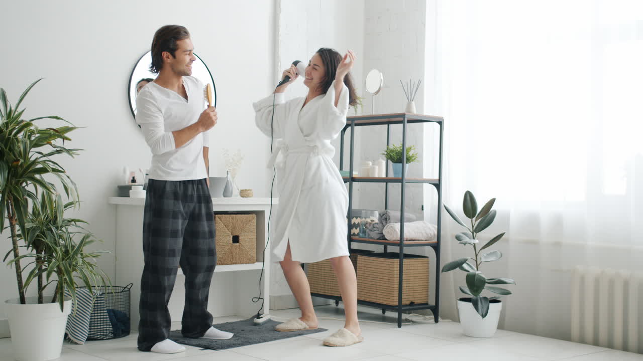 Couple Dancing in Bathroom with Hair Dryer