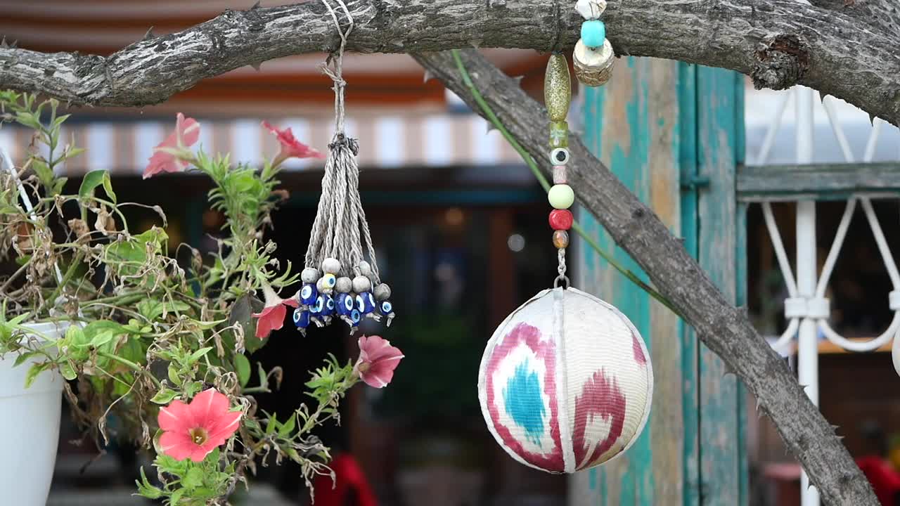 Decorative Evil Eye Beads and Ornaments Hanging from a Tree Branch