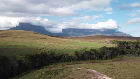 Aerial-view-of-vast-prairie-at-the-base-of-majestic-Roraima-Tepui-in-Canaima-National-Park