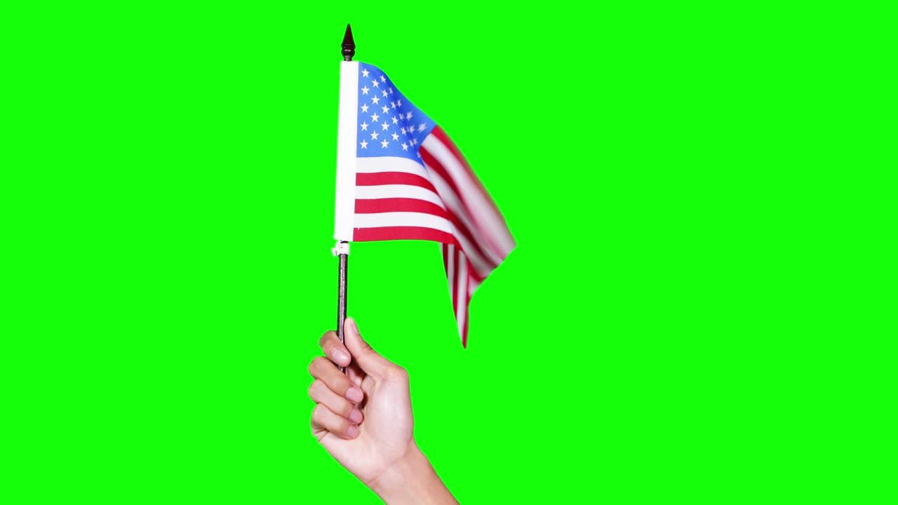 mano sosteniendo la bandera estadounidense en el estudio