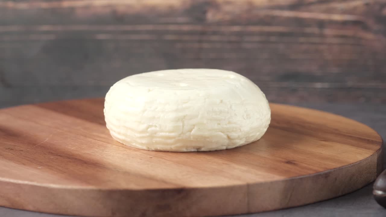 Round White Cheese on Wooden Cutting Board