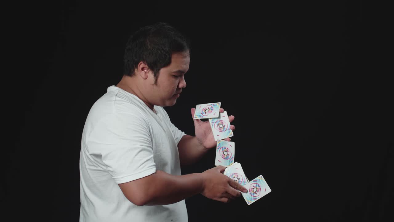 Asian Man Showing His Trick With Usual Cards