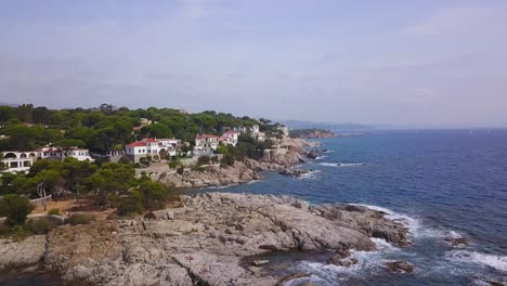 Spain-Costa-Brava-Mediterranean-coastline-aerial-view-from-the-sea-shore,-Canyelles-Grosses,-Roses,-Catalonia