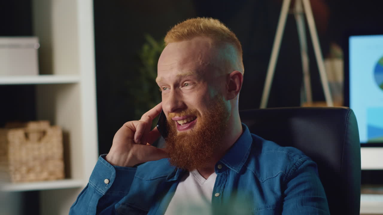 Young man calling phone in the office