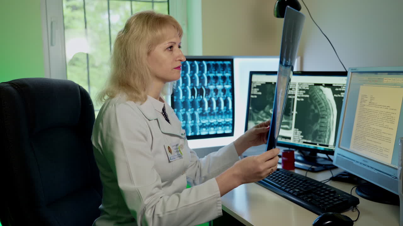 Doctor examines x ray. Female doctor looking chest x ray film in hospital
