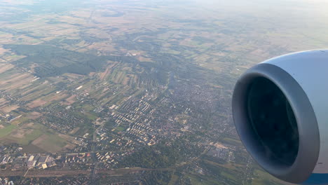 Turbine-Engine-Of-An-Airplane-Flying-In-High-Altitude-Above-Vast-Landscape