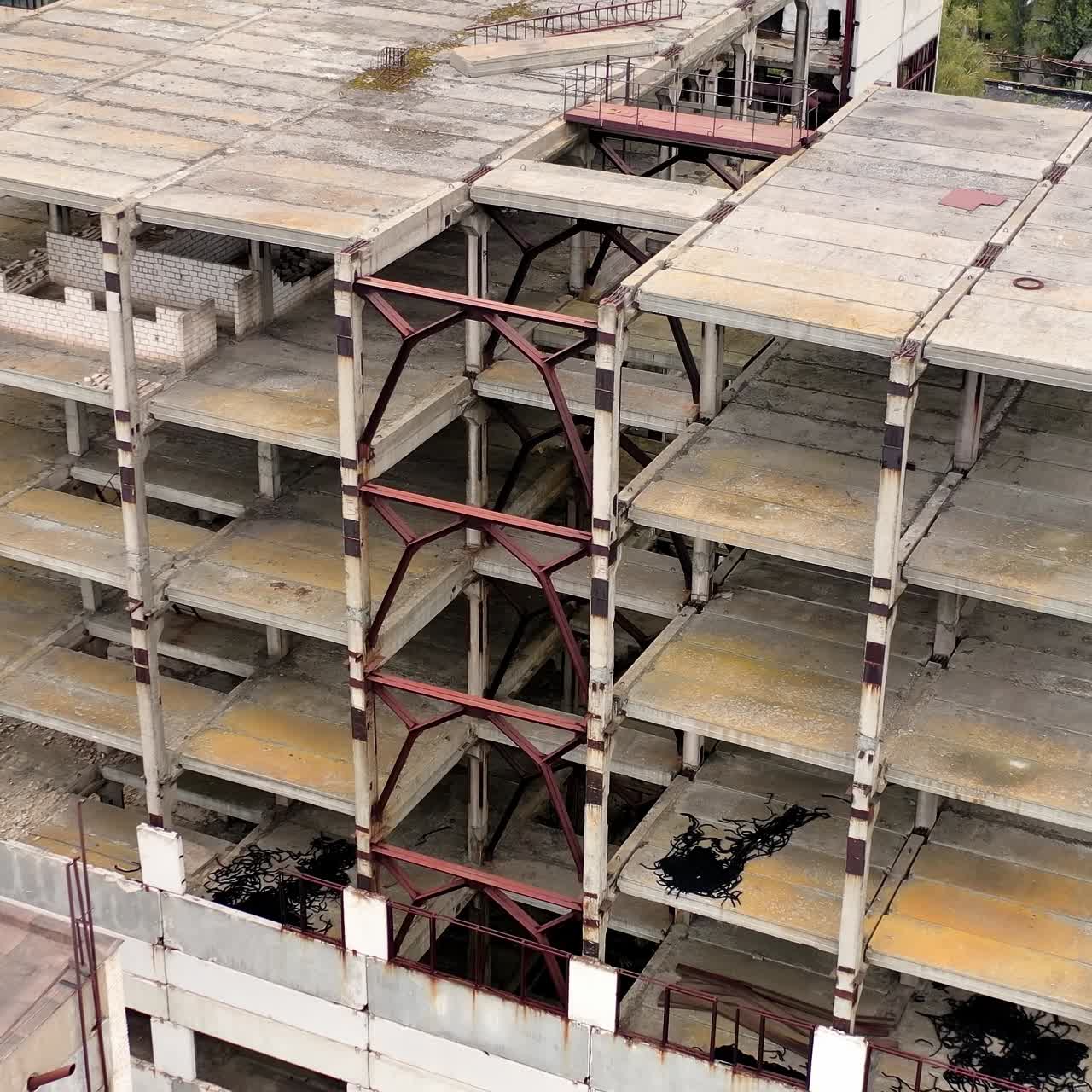 Empty destroyed factory buildings on the background. Aerial view of old abandoned factory