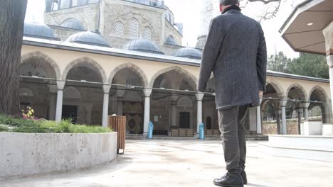 man looking at mosque